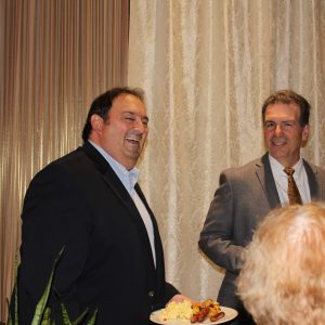 Board Member laughing with plate of food