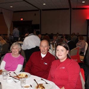 Employee Megan Berkman seated with two members