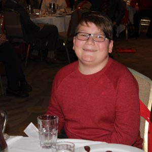 Young boy at table smiling