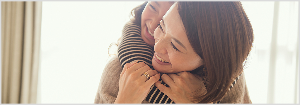 Daughter hugging mother